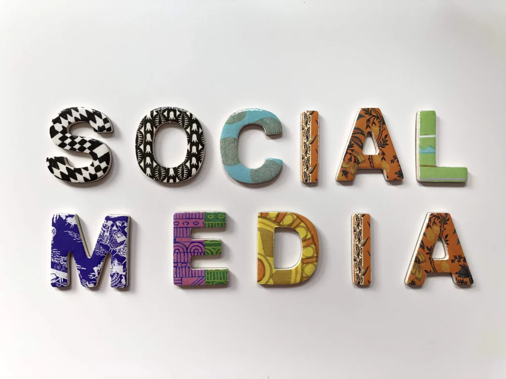 The term "Social Media" is spelled out with colorful sign letters 